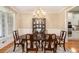 Formal dining room featuring hardwood floors, large window, chandelier and china cabinet at 4653 Glory Maple Trce, Powder Springs, GA 30127