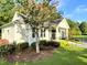 Well-manicured clubhouse exterior with vibrant flowers, inviting landscaping, and accessible ramp for easy entry at 4653 Glory Maple Trce, Powder Springs, GA 30127