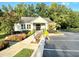 Charming clubhouse exterior features beautiful landscaping, a ramp, and well-maintained parking area, enhancing community appeal at 4653 Glory Maple Trce, Powder Springs, GA 30127