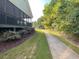 Screened porch, lush greenery and a sidewalk offer a peaceful and inviting outdoor space for residents to enjoy nature at 4653 Glory Maple Trce, Powder Springs, GA 30127