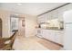 Kitchenette boasts white cabinets, granite countertops, stainless appliances, and neutral flooring at 4653 Glory Maple Trce, Powder Springs, GA 30127