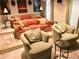 Cozy living room with comfortable seating, including an orange sofa, and accent chairs at 4653 Glory Maple Trce, Powder Springs, GA 30127