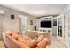 Spacious living room with comfortable seating, a large TV, and french doors at 4653 Glory Maple Trce, Powder Springs, GA 30127