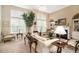 Inviting living room with large windows, fireplace, and built-in shelves filled with decorative accents at 4653 Glory Maple Trce, Powder Springs, GA 30127