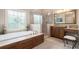 Lovely bathroom features glass enclosed shower, soaking tub and vanity with seating at 4653 Glory Maple Trce, Powder Springs, GA 30127