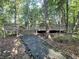 Secluded wooden deck amidst lush trees providing a serene outdoor retreat and seating at 4653 Glory Maple Trce, Powder Springs, GA 30127