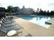 Inviting community pool area with plenty of lounge chairs and shaded pavilion, perfect for relaxation and socializing at 4653 Glory Maple Trce, Powder Springs, GA 30127