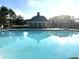 Sparkling community pool with inviting pool house and comfortable lounge chairs, perfect for relaxation and socializing at 4653 Glory Maple Trce, Powder Springs, GA 30127