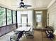 Relaxing screened porch with ceiling fan and comfortable seating area overlooking lush trees at 4653 Glory Maple Trce, Powder Springs, GA 30127