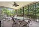 Relaxing screened porch with ceiling fan and comfortable seating area overlooking lush trees at 4653 Glory Maple Trce, Powder Springs, GA 30127