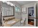 Bathroom featuring a large mirror, granite countertop, and a window allowing natural light at 595 Glenforest Rd, Sandy Springs, GA 30328