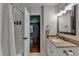 Bathroom featuring a shower with tile surround and a vanity with granite countertop at 595 Glenforest Rd, Sandy Springs, GA 30328