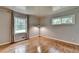 Bright bedroom featuring hardwood floors, large windows, neutral paint and minimalist modern decor at 595 Glenforest Rd, Sandy Springs, GA 30328