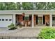 Charming front porch with brick flooring and walls, furnished with chairs, perfect for relaxing outdoors at 595 Glenforest Rd, Sandy Springs, GA 30328