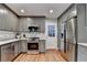 Well-lit kitchen with gray cabinets, stainless steel appliances, and hardwood floors at 595 Glenforest Rd, Sandy Springs, GA 30328