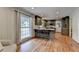 Spacious eat-in kitchen featuring wood floors, stainless appliances, and lots of natural light at 595 Glenforest Rd, Sandy Springs, GA 30328
