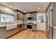 Well-lit kitchen boasts stainless appliances, a farmhouse sink, and updated cabinets at 595 Glenforest Rd, Sandy Springs, GA 30328