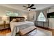 Comfortable main bedroom with a ceiling fan, lots of natural light, and a dresser at 595 Glenforest Rd, Sandy Springs, GA 30328