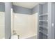 Neutral bathroom with a tub and shower combination and convenient storage shelves at 6726 Gallant Se Ct # 30, Mableton, GA 30126