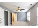 Spacious bedroom with neutral paint, two windows, ceiling fan and carpet floors at 6726 Gallant Se Ct # 30, Mableton, GA 30126