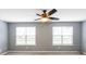 Bedroom featuring two windows and a ceiling fan with light, carpet floor and neutral colors at 6726 Gallant Se Ct # 30, Mableton, GA 30126