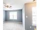 Bright primary bedroom with two windows, neutral walls, carpeted floors and a ceiling fan at 6726 Gallant Se Ct # 30, Mableton, GA 30126