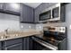 Gray cabinets, granite countertops, and stainless steel oven at 6726 Gallant Se Ct # 30, Mableton, GA 30126