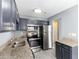 Modern kitchen with stainless steel appliances, gray cabinets, and granite countertops at 6726 Gallant Se Ct # 30, Mableton, GA 30126