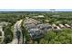 Aerial view of 908 Catamaran Ct townhomes in a wooded setting near The Avalon and other community amenities at 908 Catamaran Ct, Alpharetta, GA 30005