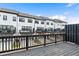 View from deck shows multi-story townhomes with black framed windows at 908 Catamaran Ct, Alpharetta, GA 30005