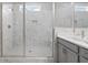 Walk-in shower featuring sleek glass enclosure and built-in bench, creating a luxurious and spa-like experience at 908 Catamaran Ct, Alpharetta, GA 30005