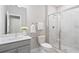 Modern bathroom with marble tile shower, grey vanity and white fixtures at 908 Catamaran Ct, Alpharetta, GA 30005