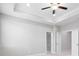 Spacious bedroom featuring elegant white trim, providing a clean and polished aesthetic with doors to other rooms at 908 Catamaran Ct, Alpharetta, GA 30005