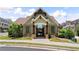 Exterior of the neighborhood clubhouse features stone and shake facade and gated pool area at 908 Catamaran Ct, Alpharetta, GA 30005