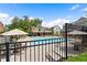 View of the community pool, featuring seating and a clubhouse with a covered patio area at 908 Catamaran Ct, Alpharetta, GA 30005