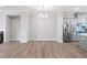 Dining area adjacent to kitchen with hardwood floors and modern chandelier at 908 Catamaran Ct, Alpharetta, GA 30005