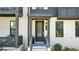 Elegant townhouse entrance featuring white painted brick, black trim, and a covered porch at 908 Catamaran Ct, Alpharetta, GA 30005