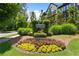 The Carvelle at Windward Park entrance sign is surrounded by colorful flowers and lush greenery at 908 Catamaran Ct, Alpharetta, GA 30005