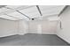 Spacious two car garage with sealed concrete floors and white ceiling with overhead door hardware at 908 Catamaran Ct, Alpharetta, GA 30005