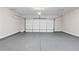 Two car garage with sealed concrete floors and view of the overhead garage door at 908 Catamaran Ct, Alpharetta, GA 30005