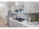 Close up of the kitchen showcasing stainless steel gas range and custom backsplash at 908 Catamaran Ct, Alpharetta, GA 30005