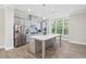 Modern kitchen with stainless steel appliances, a large island, and sleek gray cabinetry at 908 Catamaran Ct, Alpharetta, GA 30005