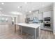 Modern kitchen with stainless steel appliances, a large island, and sleek gray cabinetry at 908 Catamaran Ct, Alpharetta, GA 30005