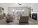 Bright living room featuring a fireplace, neutral tones, lots of windows and a ceiling fan at 908 Catamaran Ct, Alpharetta, GA 30005