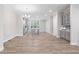 Open living space with hardwood floors, pendant lights, gray cabinets, and kitchen island at 908 Catamaran Ct, Alpharetta, GA 30005