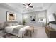 Well-lit main bedroom features a king bed, ceiling fan and an accent wall at 908 Catamaran Ct, Alpharetta, GA 30005