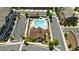 Aerial view of a community pool with lounge chairs and umbrellas surrounded by condo buildings and lush landscaping at 908 Catamaran Ct, Alpharetta, GA 30005
