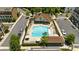 Aerial view showcasing the sparkling pool, pool house, lounge area and lush landscaping in a townhome community at 908 Catamaran Ct, Alpharetta, GA 30005