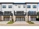 Rear of the home features a patio and a two car garage with black and white doors at 908 Catamaran Ct, Alpharetta, GA 30005
