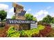 Windward Park sign with stone base surrounded by a variety of colorful flowers and shrubbery at 908 Catamaran Ct, Alpharetta, GA 30005
